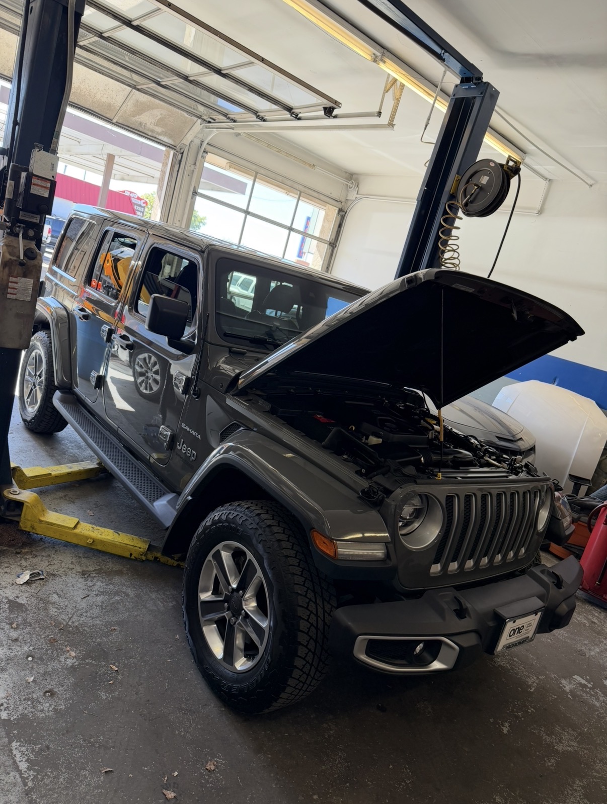 Jeep Wrangler on the lift for service at LG Automotive